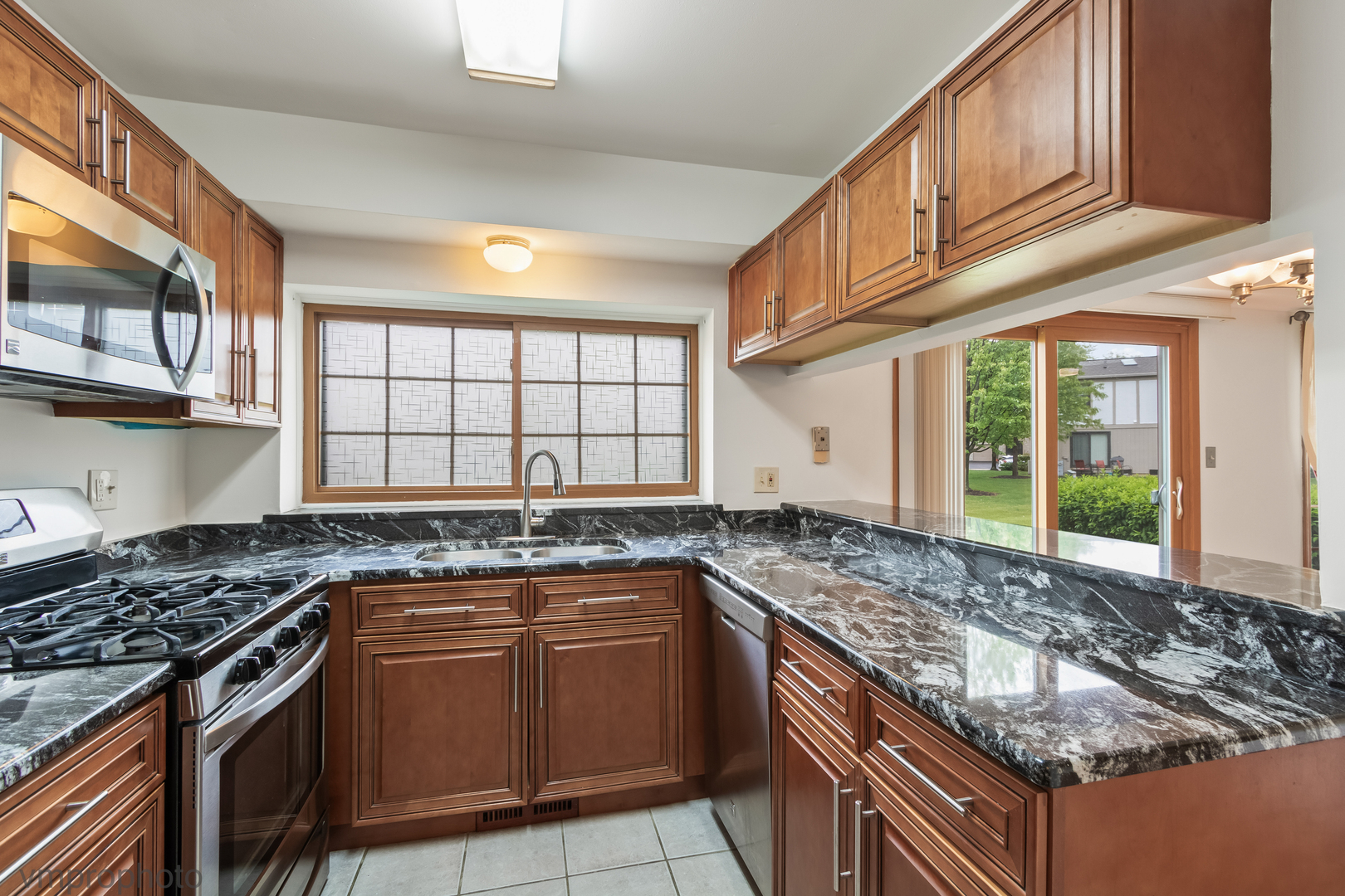 4549 Topaz Drive Hoffman Estates, IL 60192 - Photo 6 of 20 a kitchen with granite countertop a sink and a stove