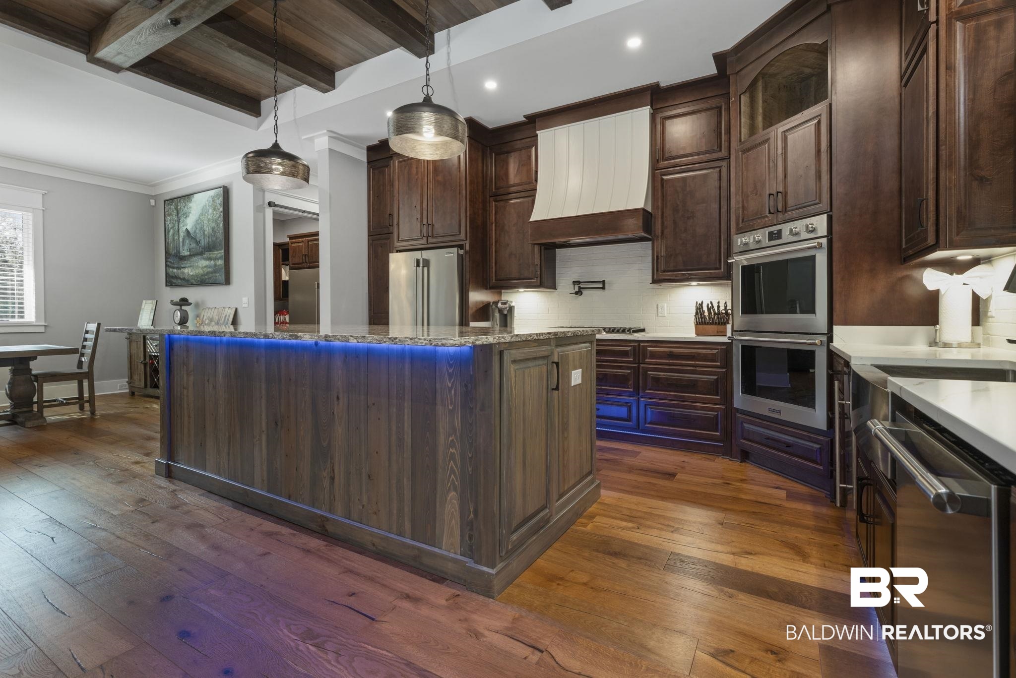 9501 Ben Hamilton Road Theodore, AL 36582 - Photo 19 of 69 Kitchen with dark wood-style flooring, decorative backsplash, a center island, stainless steel appliances, and light stone countertops
