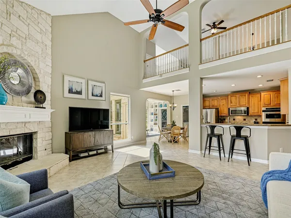 a living room with furniture a flat screen tv and a fireplace
