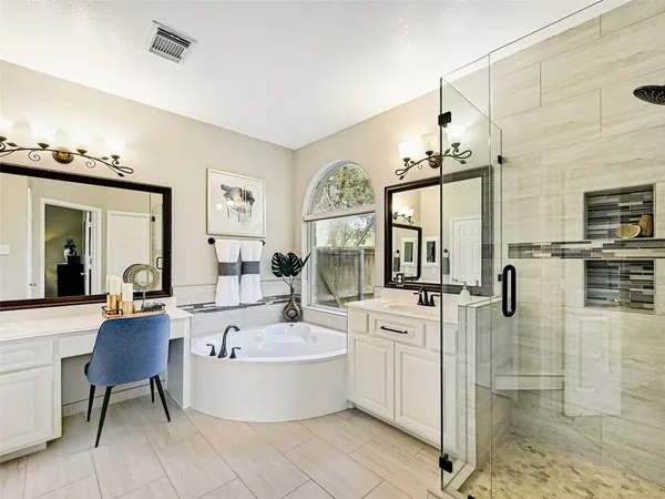 a large white kitchen with a large island