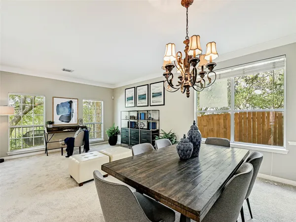 a dining room with furniture potted plants and wooden floor