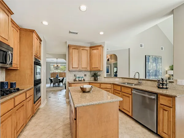 a large kitchen with a sink and cabinets