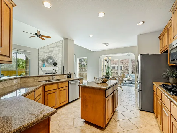 a kitchen that has a sink and a stove in it