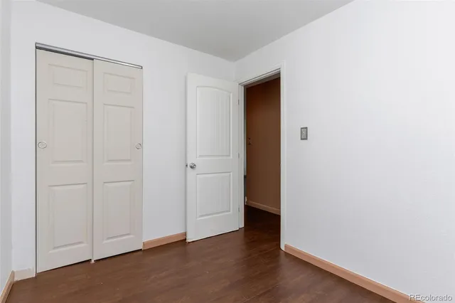 an empty room with wooden floor