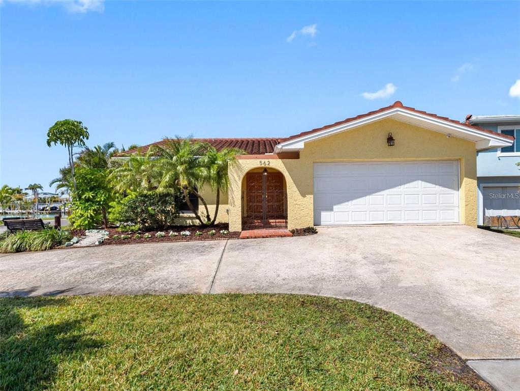 562 Johns Pass Avenue Madeira Beach, FL 33708 - Photo 13 of 51 a front view of a house with a yard