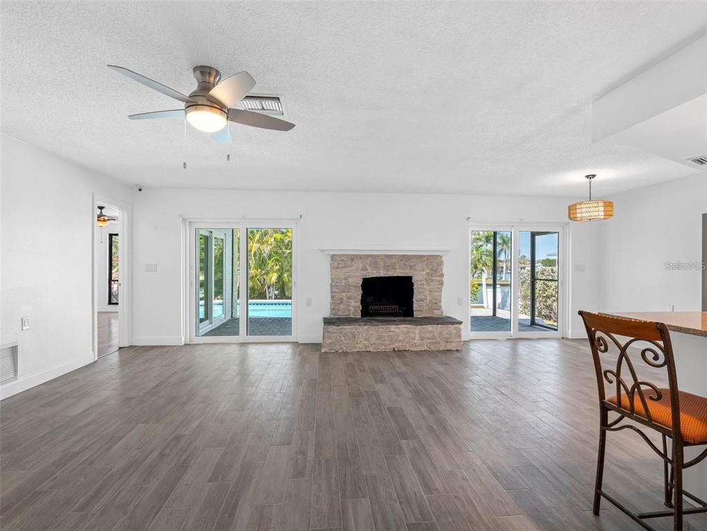 562 Johns Pass Avenue Madeira Beach, FL 33708 - Photo 19 of 51 a view of an empty room with wooden floor and a window