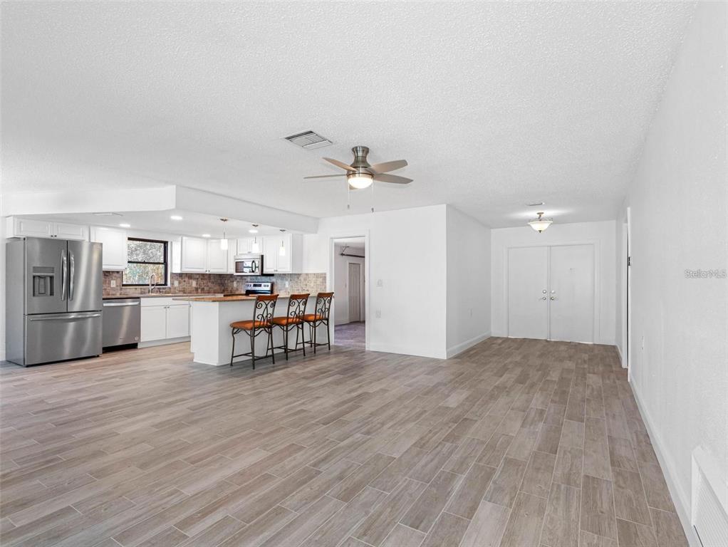 562 Johns Pass Avenue Madeira Beach, FL 33708 - Photo 20 of 51 a view of kitchen with furniture and wooden floor