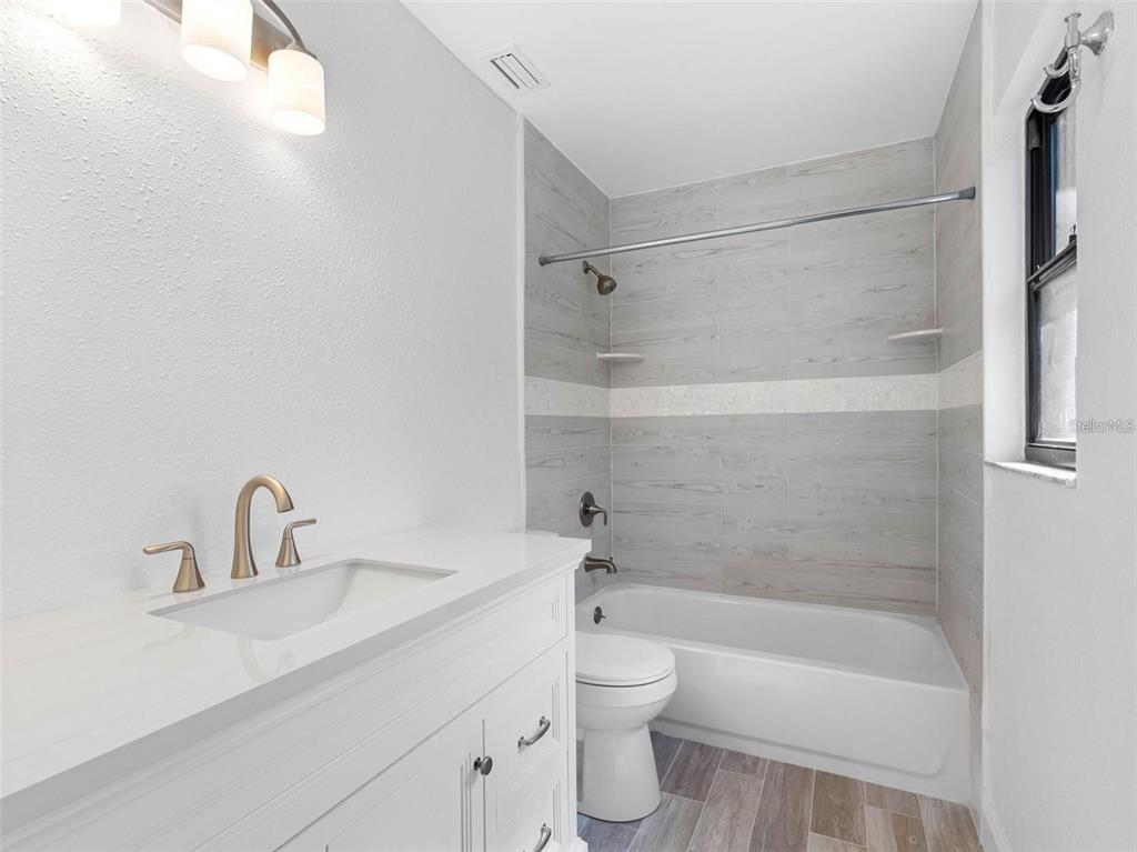 562 Johns Pass Avenue Madeira Beach, FL 33708 - Photo 34 of 51 a bathroom with a sink toilet and shower
