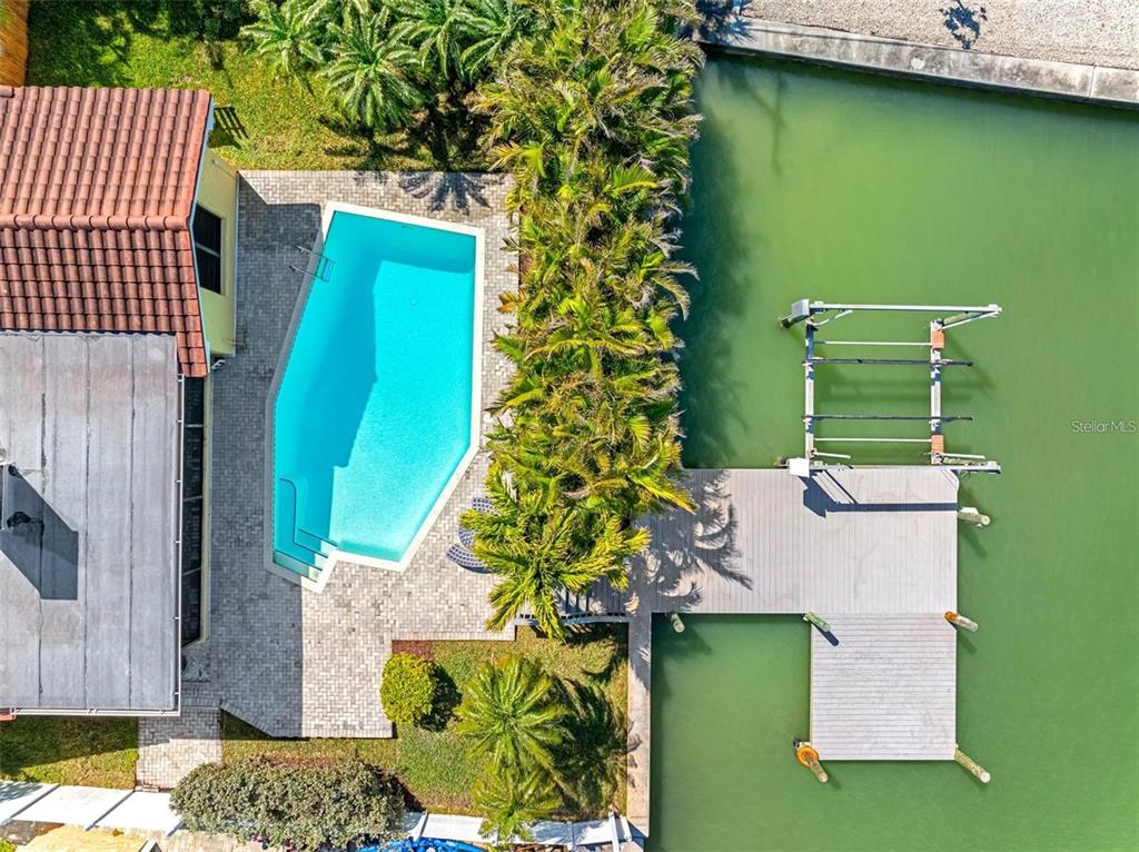 562 Johns Pass Avenue Madeira Beach, FL 33708 - Photo 6 of 51 an aerial view of a house with a garden and swimming pool