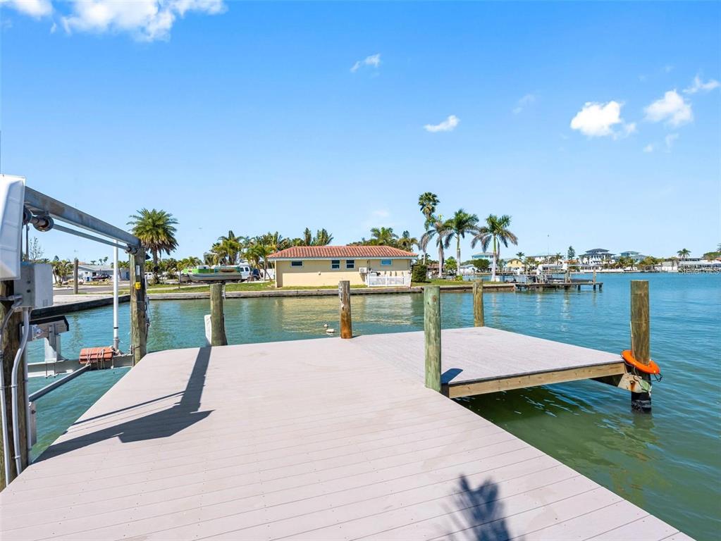 562 Johns Pass Avenue Madeira Beach, FL 33708 - Photo 9 of 51 a swimming pool with outdoor seating and yard