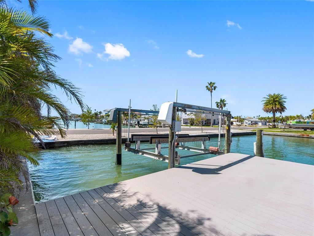 562 Johns Pass Avenue Madeira Beach, FL 33708 - Photo 10 of 51 a view of a lake with lawn chairs