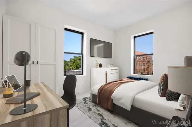 a bedroom with a bed and a large window