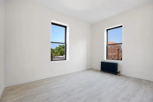 an empty room with windows and closet