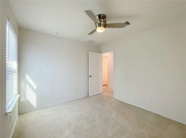 a view of an empty room and a window