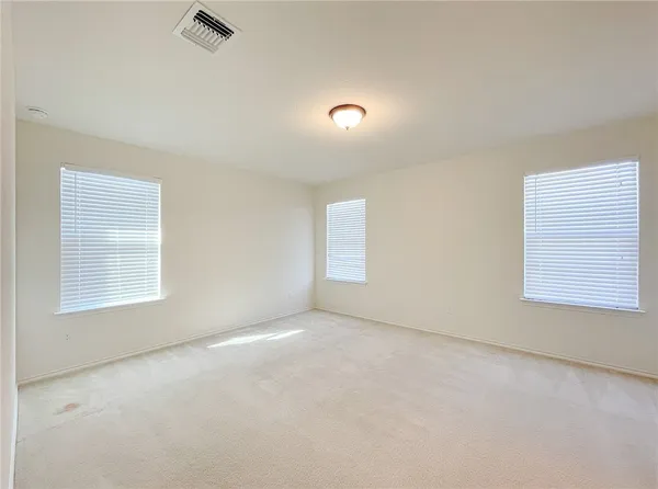 an empty room with a empty space and windows
