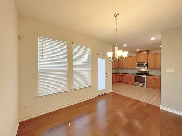 a view of a kitchen with a stove cabinets and a wooden floor