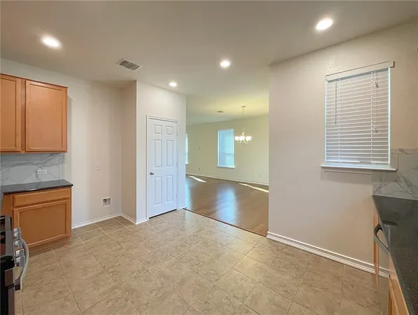 a view of empty room with window and fireplace