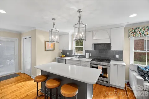 a kitchen with a stove a refrigerator and a sink