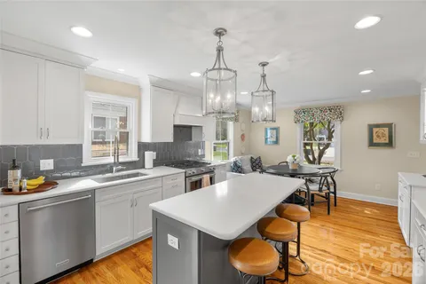 a large kitchen with a table and chairs in it