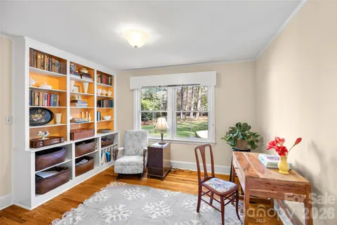 a living room with furniture and a book shelf