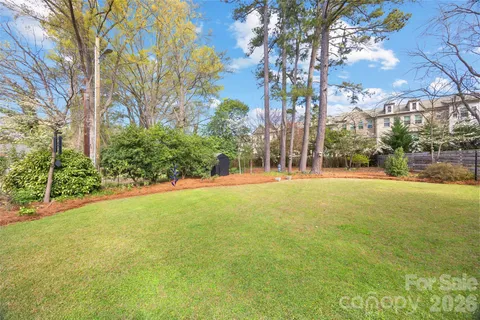 a front view of house with yard and trees in the background