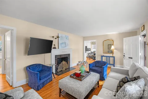 a living room with furniture flat screen tv and a fireplace