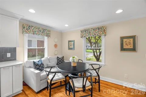 a dining room with furniture and window
