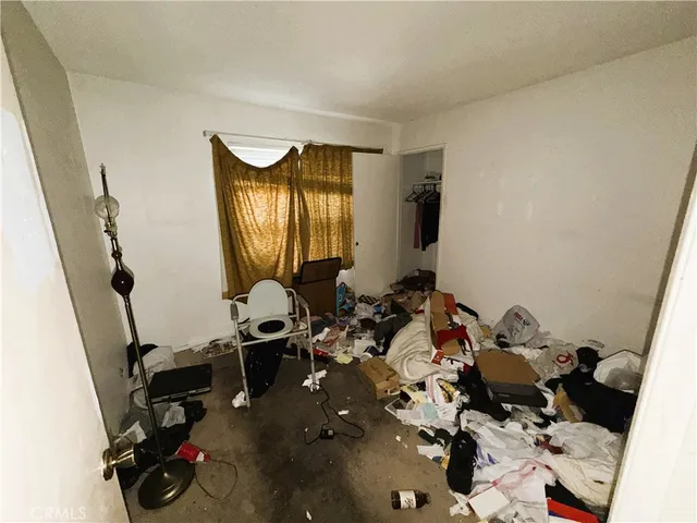 a view of a house with backyard sitting area and garden