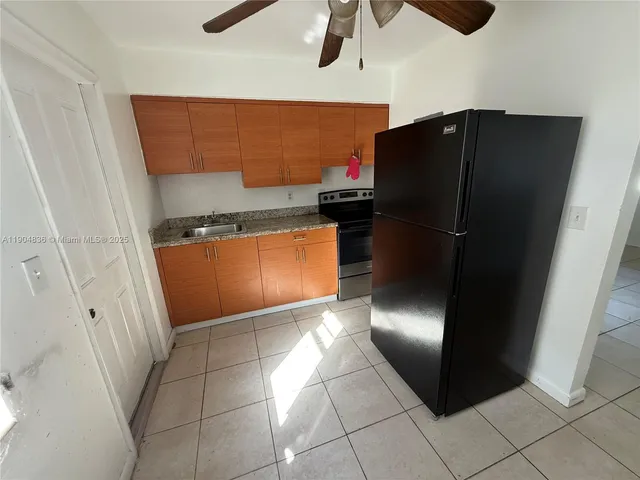 a kitchen with stainless steel appliances granite countertop a refrigerator and a stove