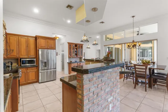 a large kitchen with lots of counter space and furniture