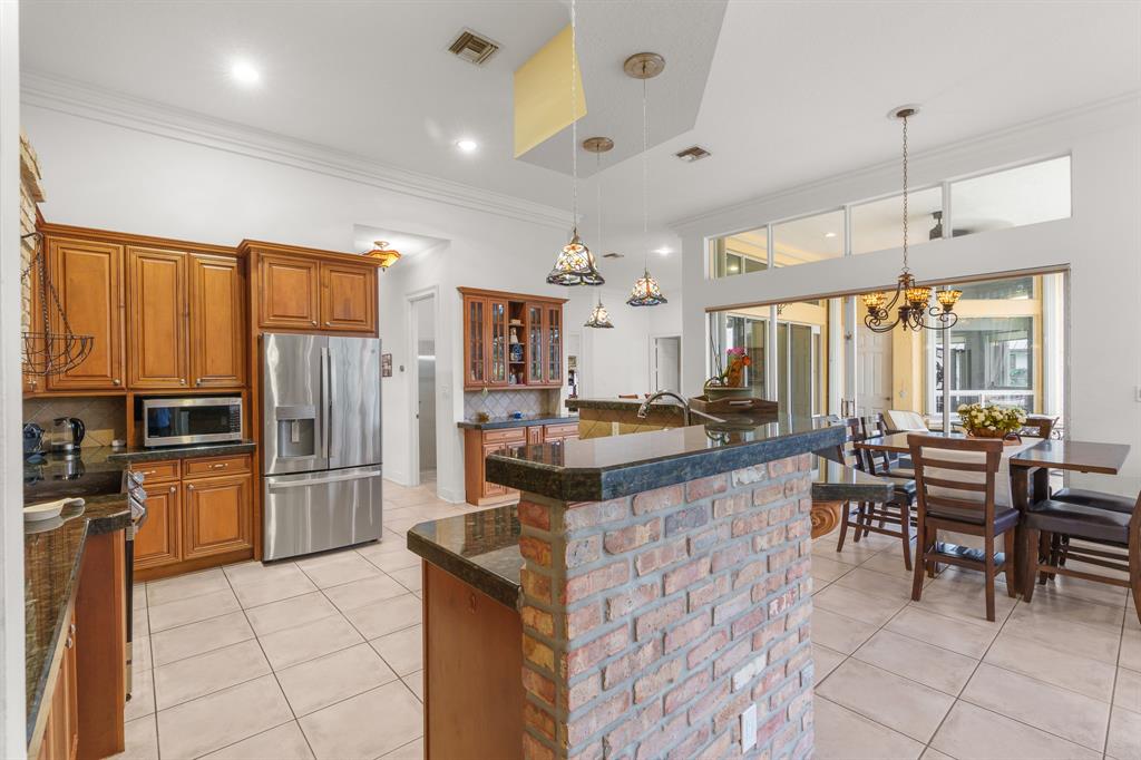 5973 Southwest 54th Court Davie, FL 33314 - Photo 12 of 49 a large kitchen with lots of counter space and furniture