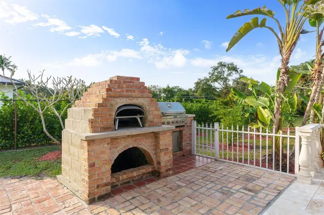 a view of a grey house with a yard