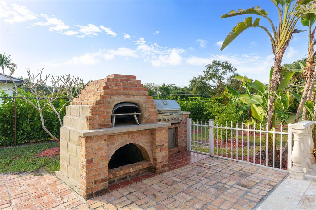 5973 Southwest 54th Court Davie, FL 33314 - Photo 16 of 49 a view of a grey house with a yard