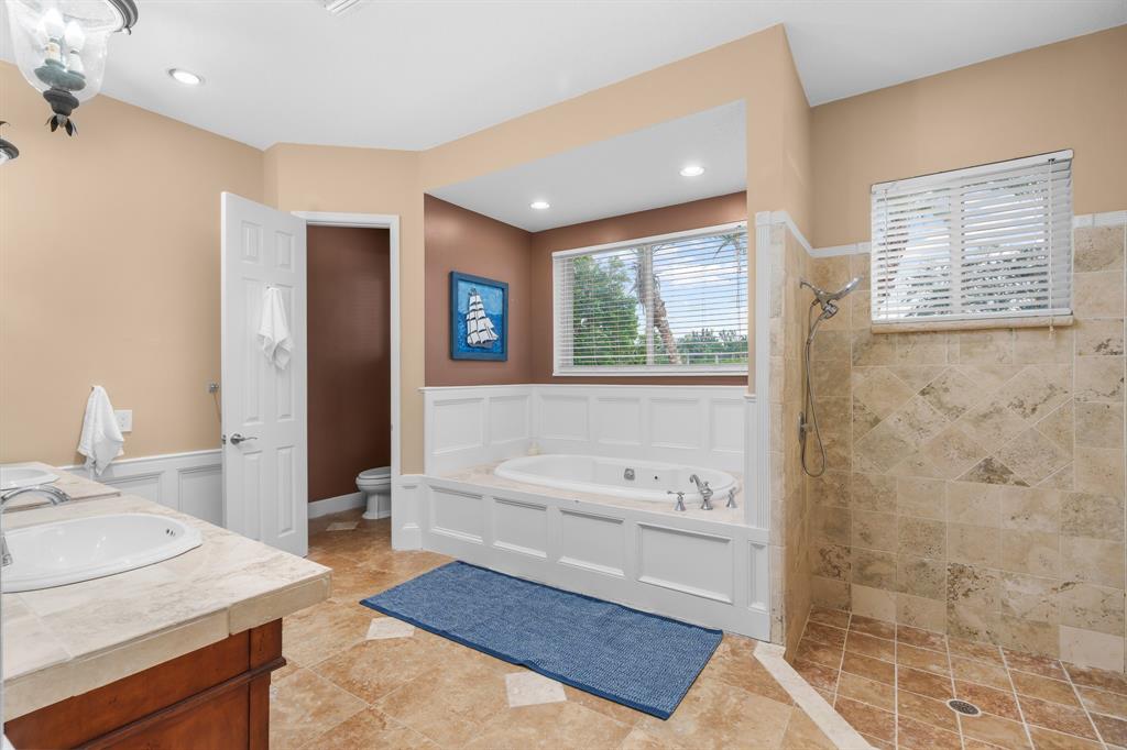 5973 Southwest 54th Court Davie, FL 33314 - Photo 21 of 49 a spacious bathroom with a tub sink and mirror