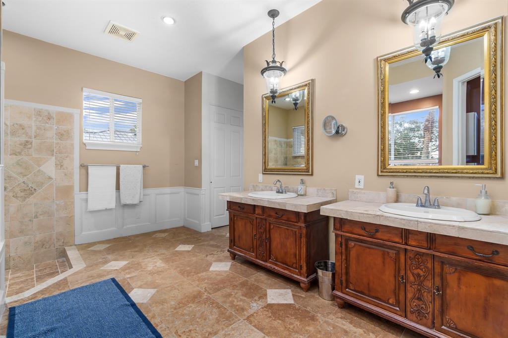 5973 Southwest 54th Court Davie, FL 33314 - Photo 22 of 49 a spacious bathroom with a double vanity sink a mirror and a bathtub