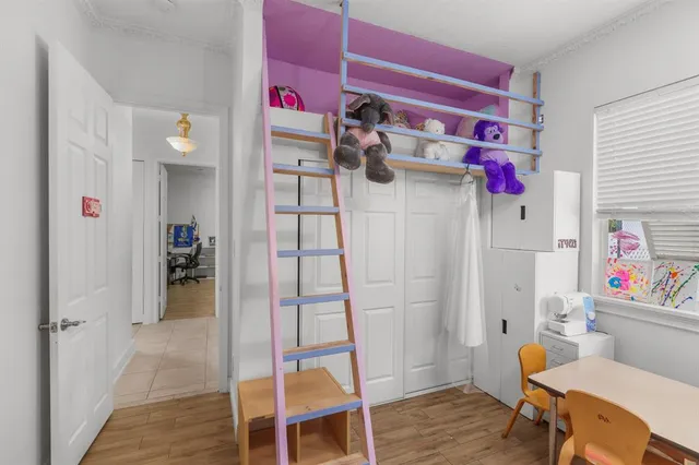 a view of a room that has a table and a chair in it