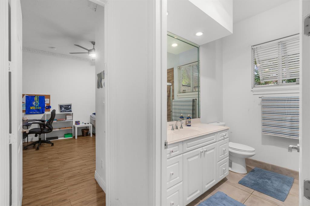 5973 Southwest 54th Court Davie, FL 33314 - Photo 25 of 49 a bathroom with a sink a toilet and a mirror