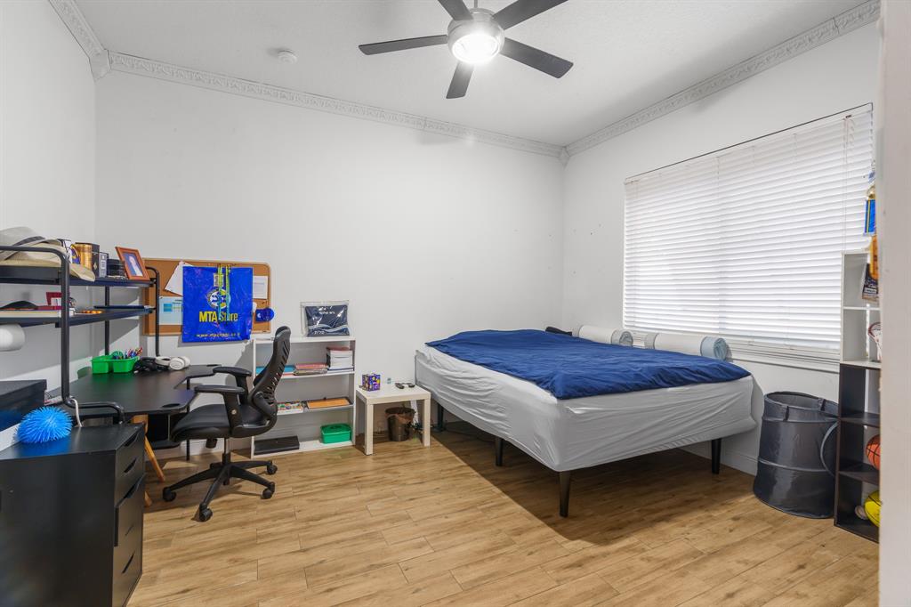 5973 Southwest 54th Court Davie, FL 33314 - Photo 27 of 49 a bedroom with furniture and a book shelf