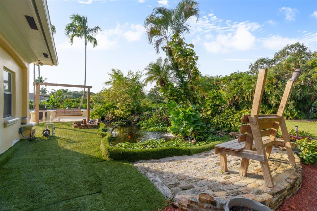 5973 Southwest 54th Court Davie, FL 33314 - Photo 29 of 49 a view of a chair and table in backyard