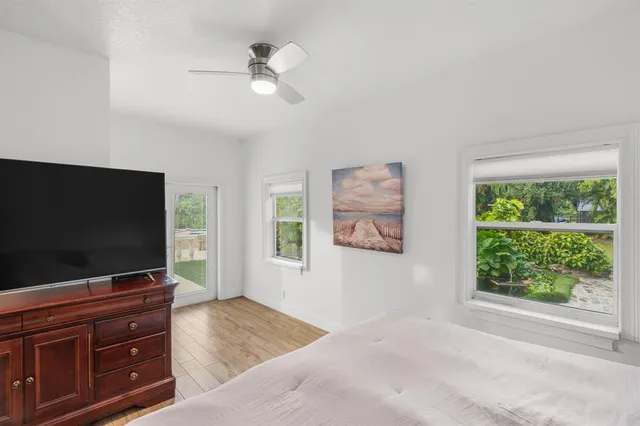 a bedroom with furniture and a flat screen tv
