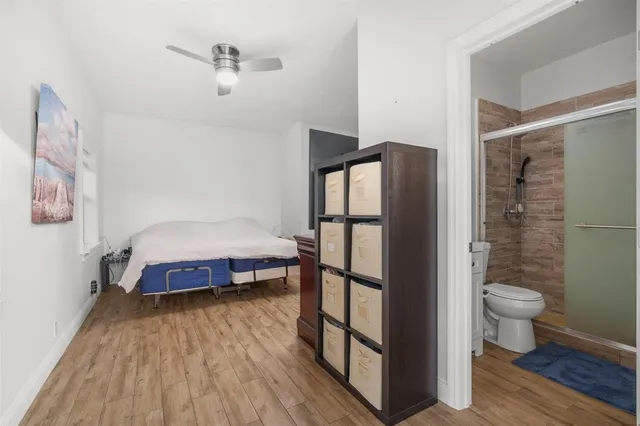 a spacious bedroom with a bed and a shower