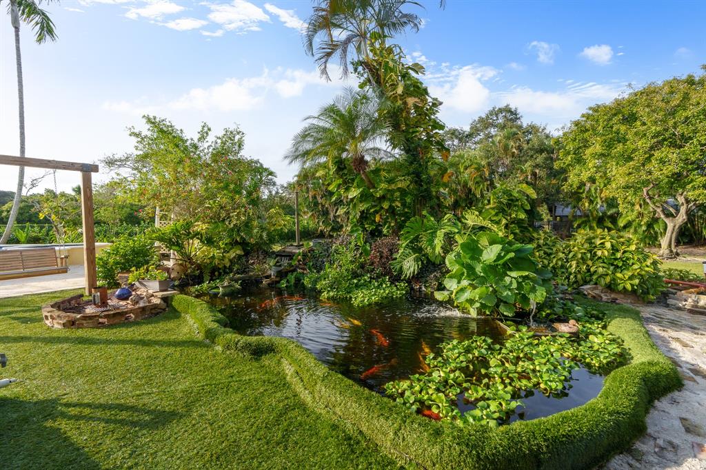 5973 Southwest 54th Court Davie, FL 33314 - Photo 34 of 49 a view of a garden with a tree in the background