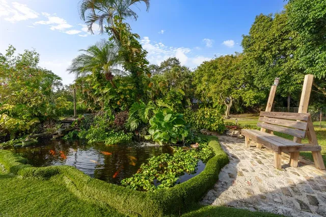 a backyard of a house with table and chairs