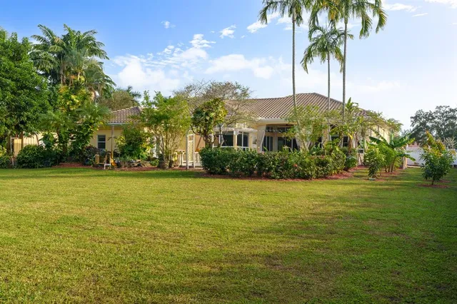 a front view of house with yard and trees