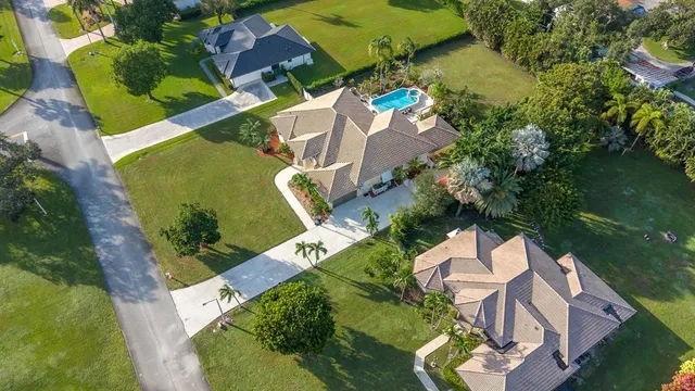 an aerial view of a house with outdoor space and a lake view