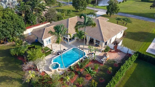 an aerial view of a house with outdoor space and lake view