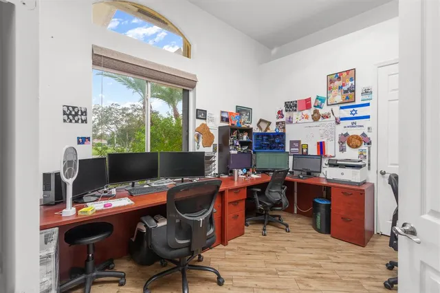 a view of a workspace with furniture and a window