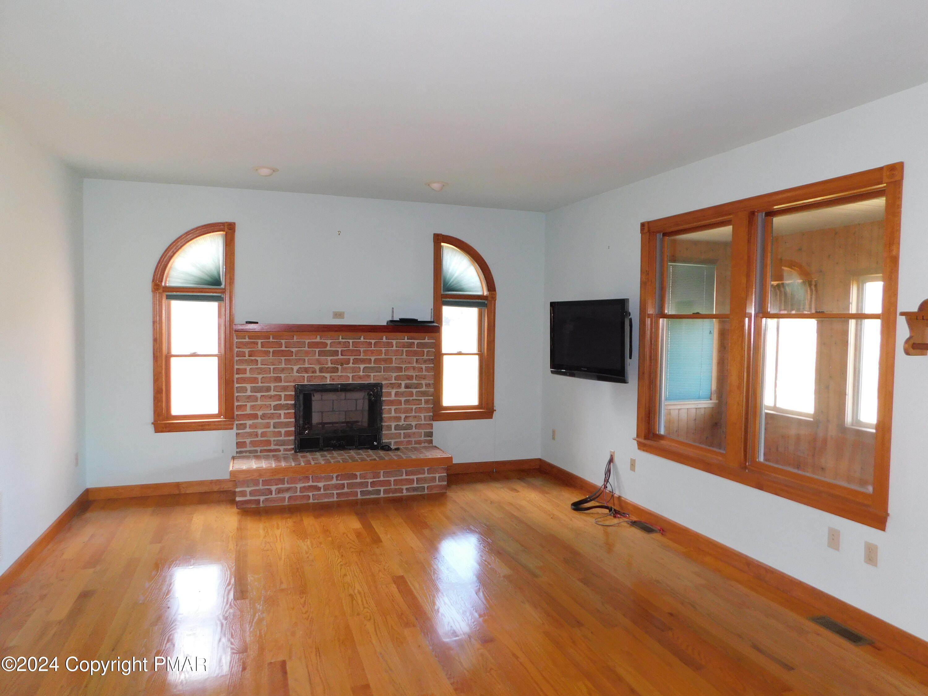 1258 Beaver Valley Road Stroudsburg, PA 18360 - Photo 8 of 65 a living room with a fireplace and wooden floor