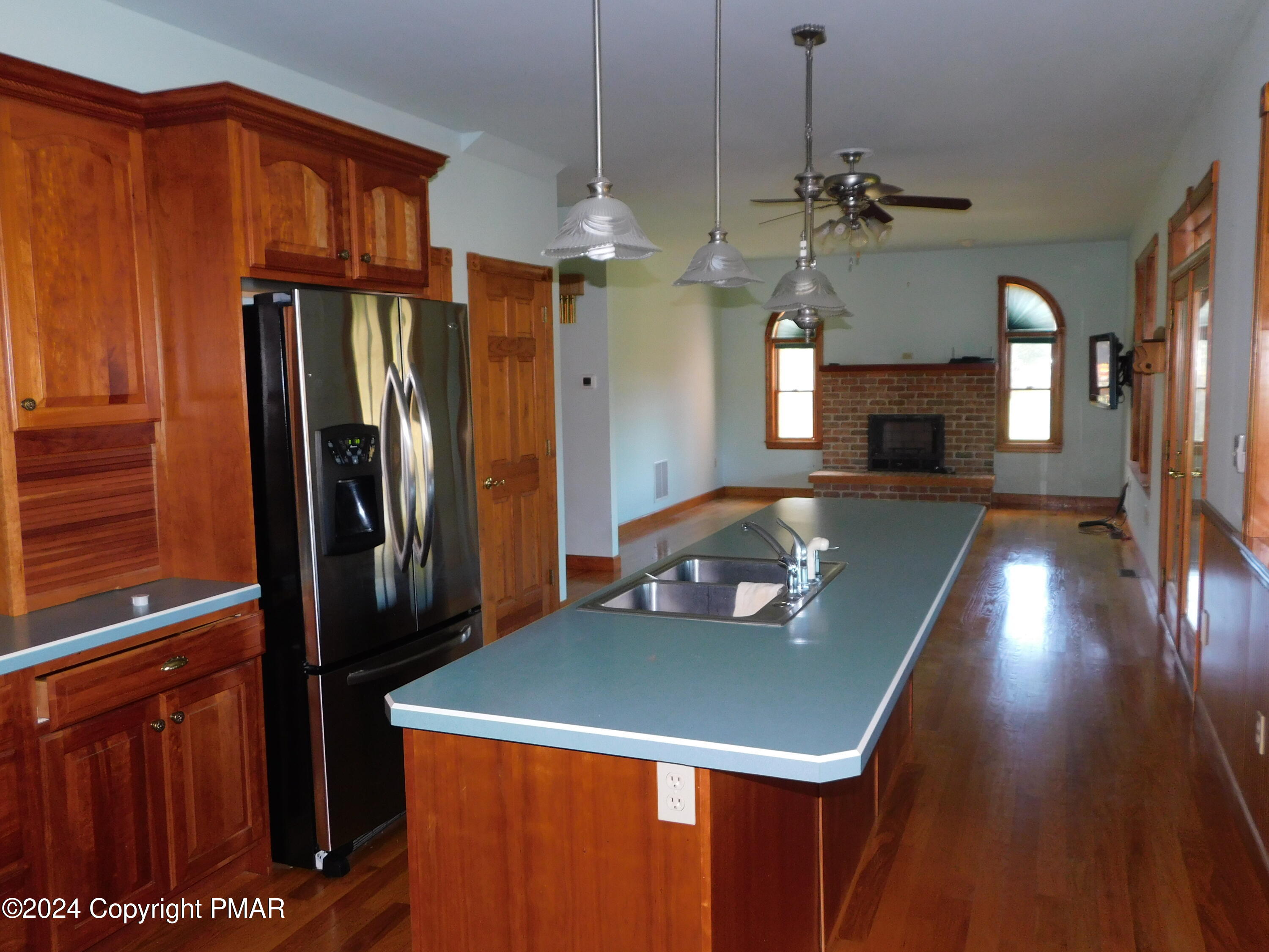 1258 Beaver Valley Road Stroudsburg, PA 18360 - Photo 10 of 65 a view of a kitchen with a refrigerator ceiling fan and wooden floor