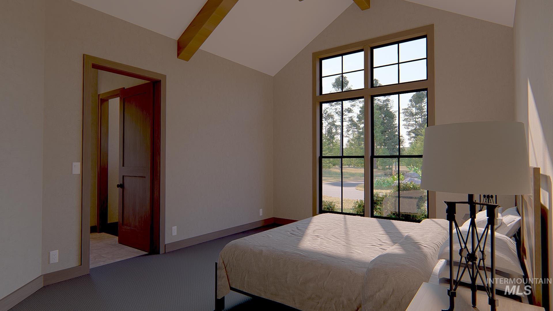 212 Rawhide Loop McCall, ID 83638 - Photo 10 of 28 Carpeted bedroom with beam ceiling and high vaulted ceiling